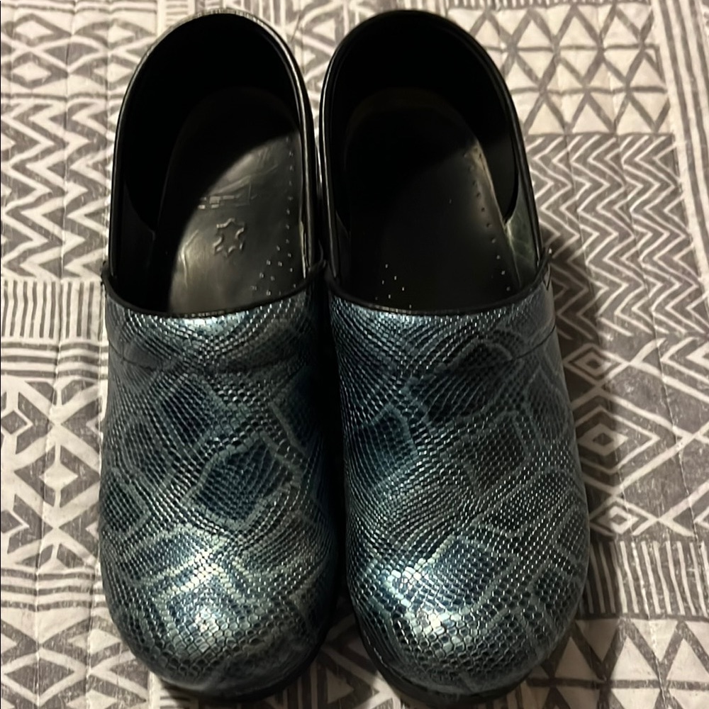 Dansko blue snakeskin clogs.
